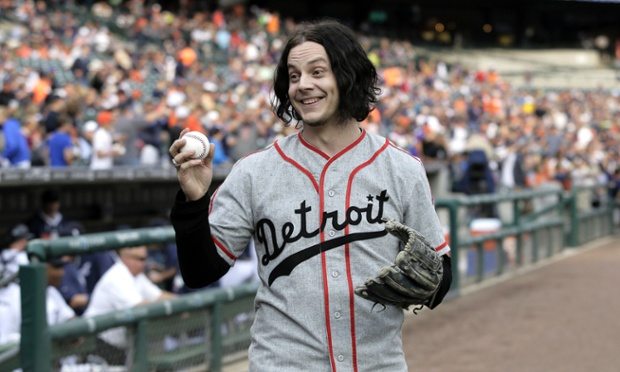 FILE - In this July 29, 2014 file photo, musician Jack White shows off a baseball before throwing out the ceremonial first pitch before the Detroit Tigers baseball game against the Chicago White Sox in Detroit. White is planning a return to his Detroit roots with a new Third Man Records store. White and Shinola, a business that makes watches and other goods in Detroit, announced Tuesday, June 2, 2015, they've partnered to buy the building housing Shinola. (AP Photo/Duane Burleson)