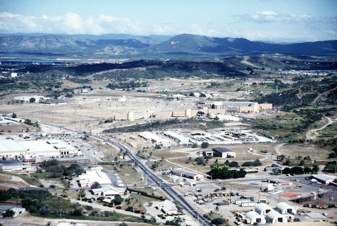An aerial view of Naval Base Guantanamo Bay's windward side, looking northeast, showing the Navy Exchange and the Bachelor Enlisted Quarters (BEQ) area.